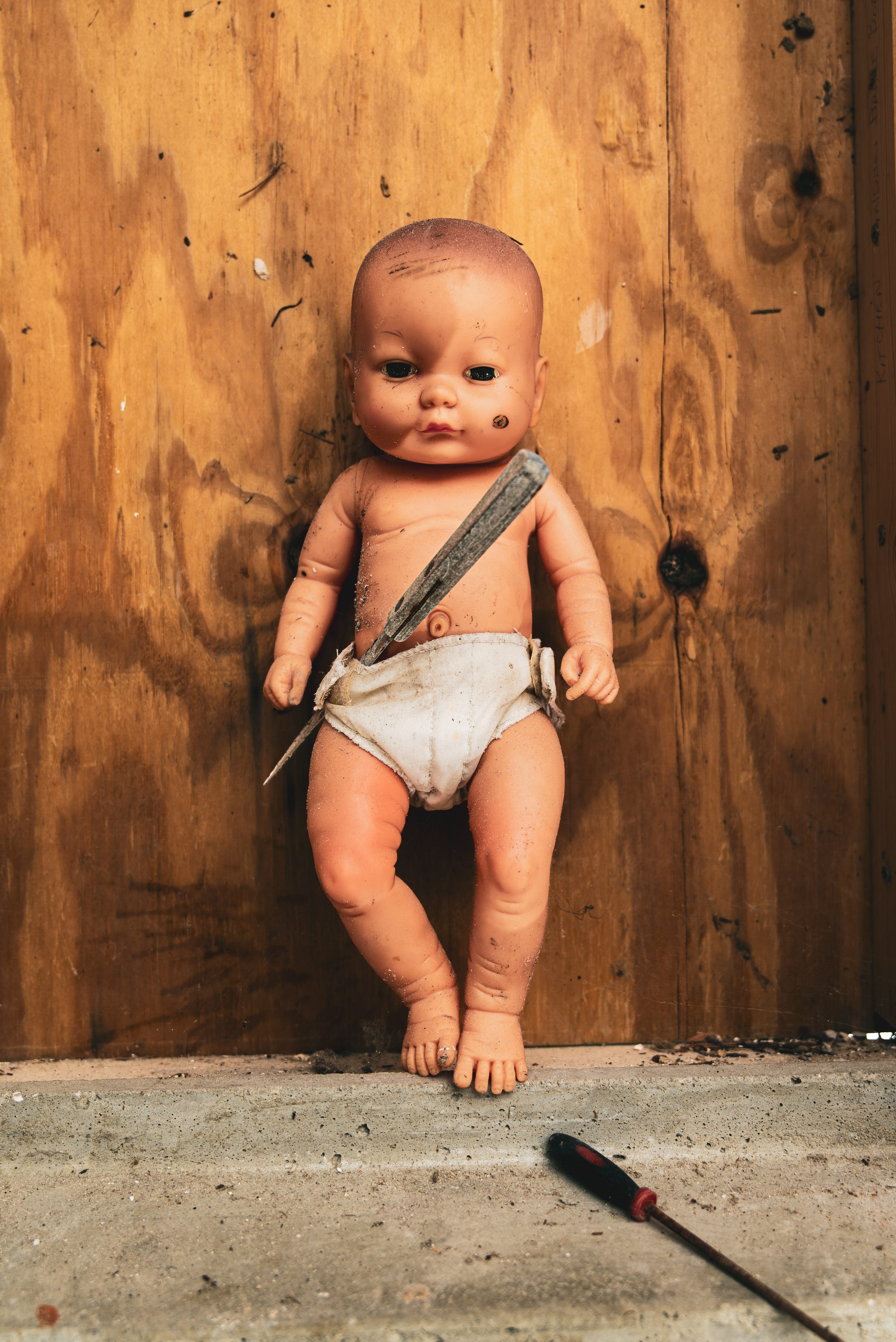 A child's toy lies among storm debris.