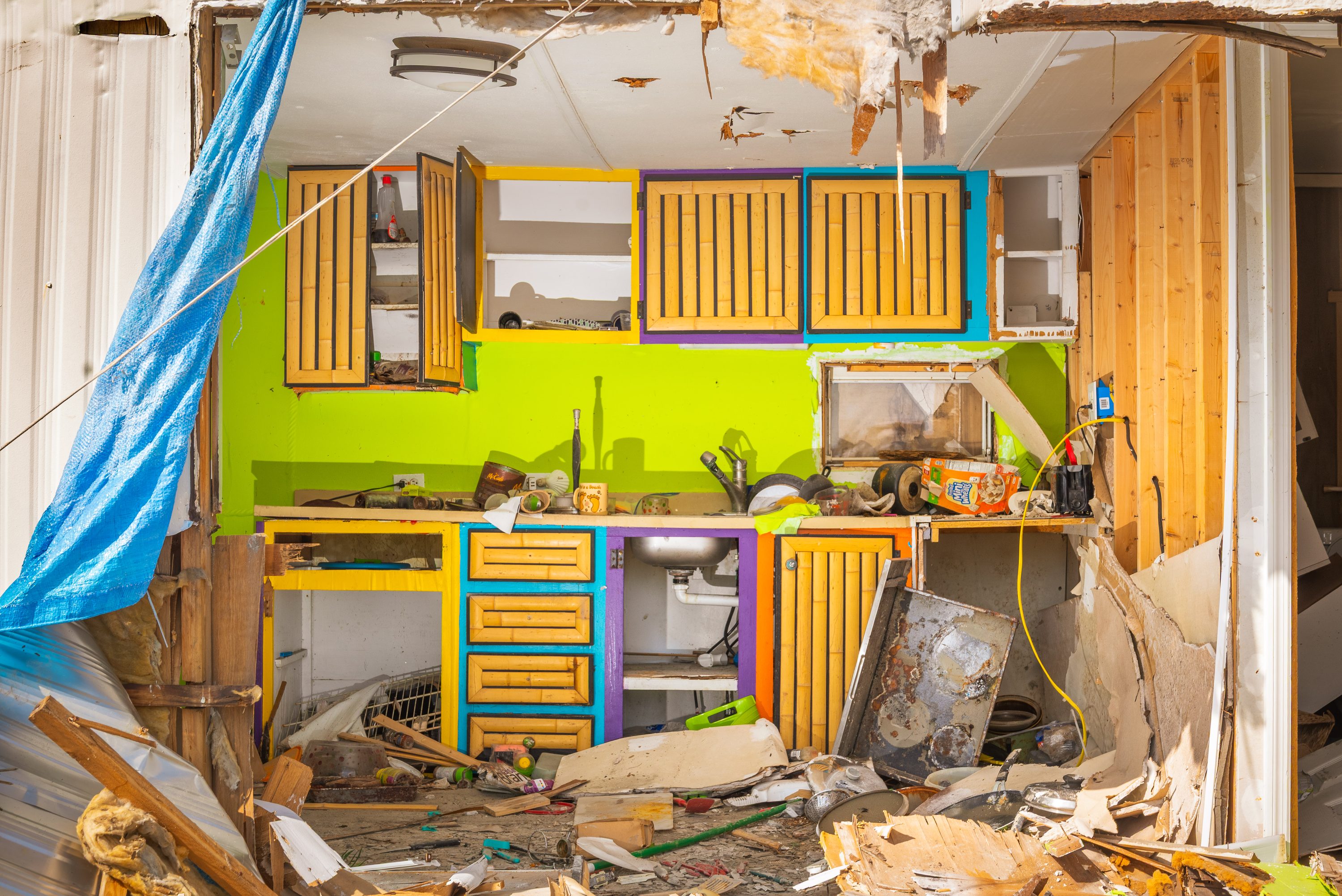 A house torn open by the hurricane, its rooms exposed to the street.