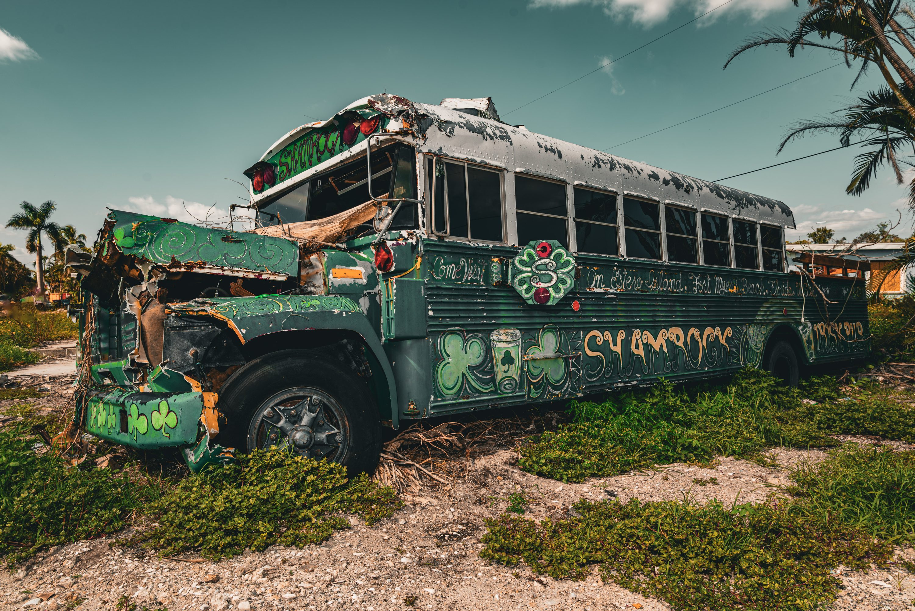 A school bus sits wrecked among hurricane debris.