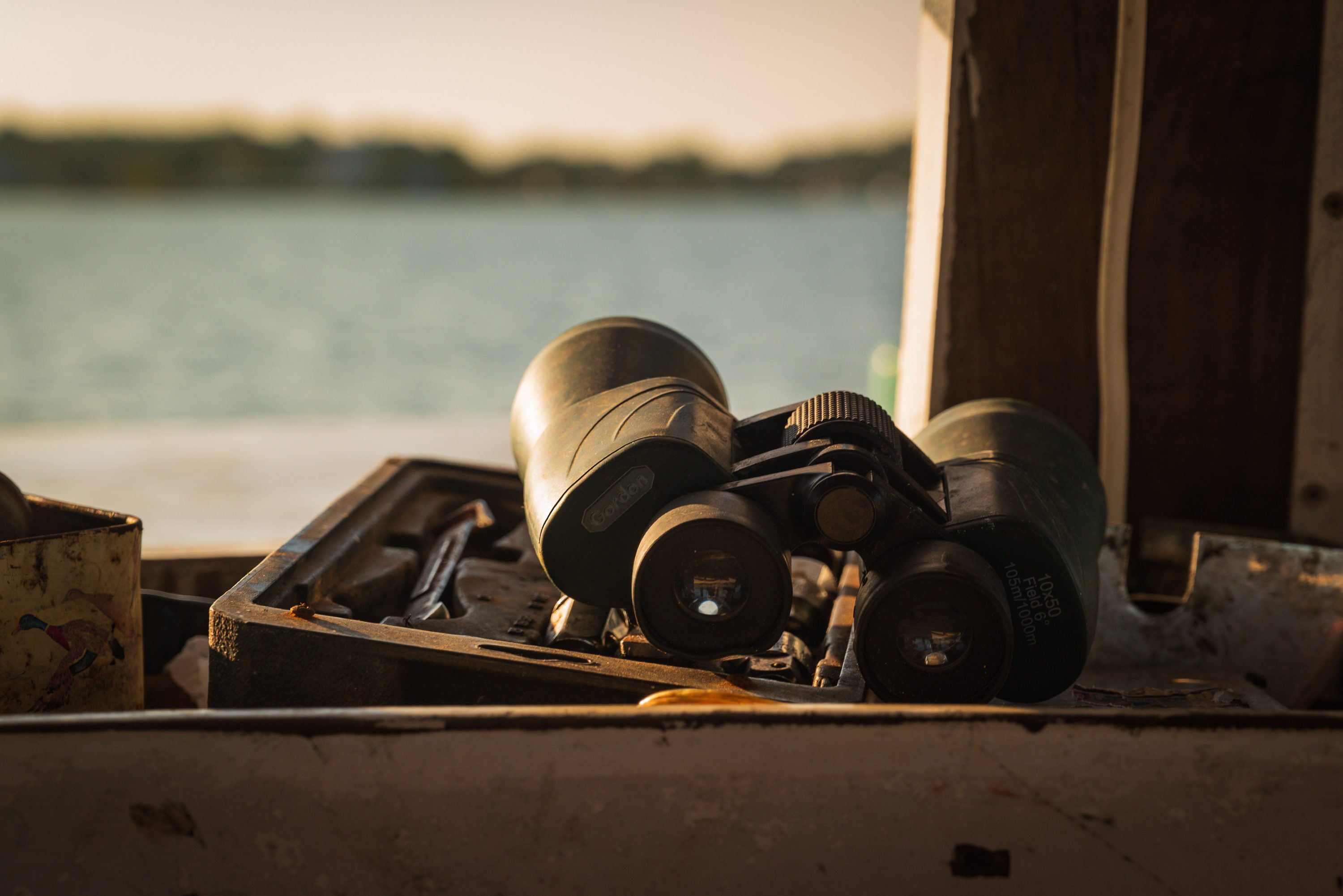 Hands shuck oysters over a pile of shells aboard a workboat.