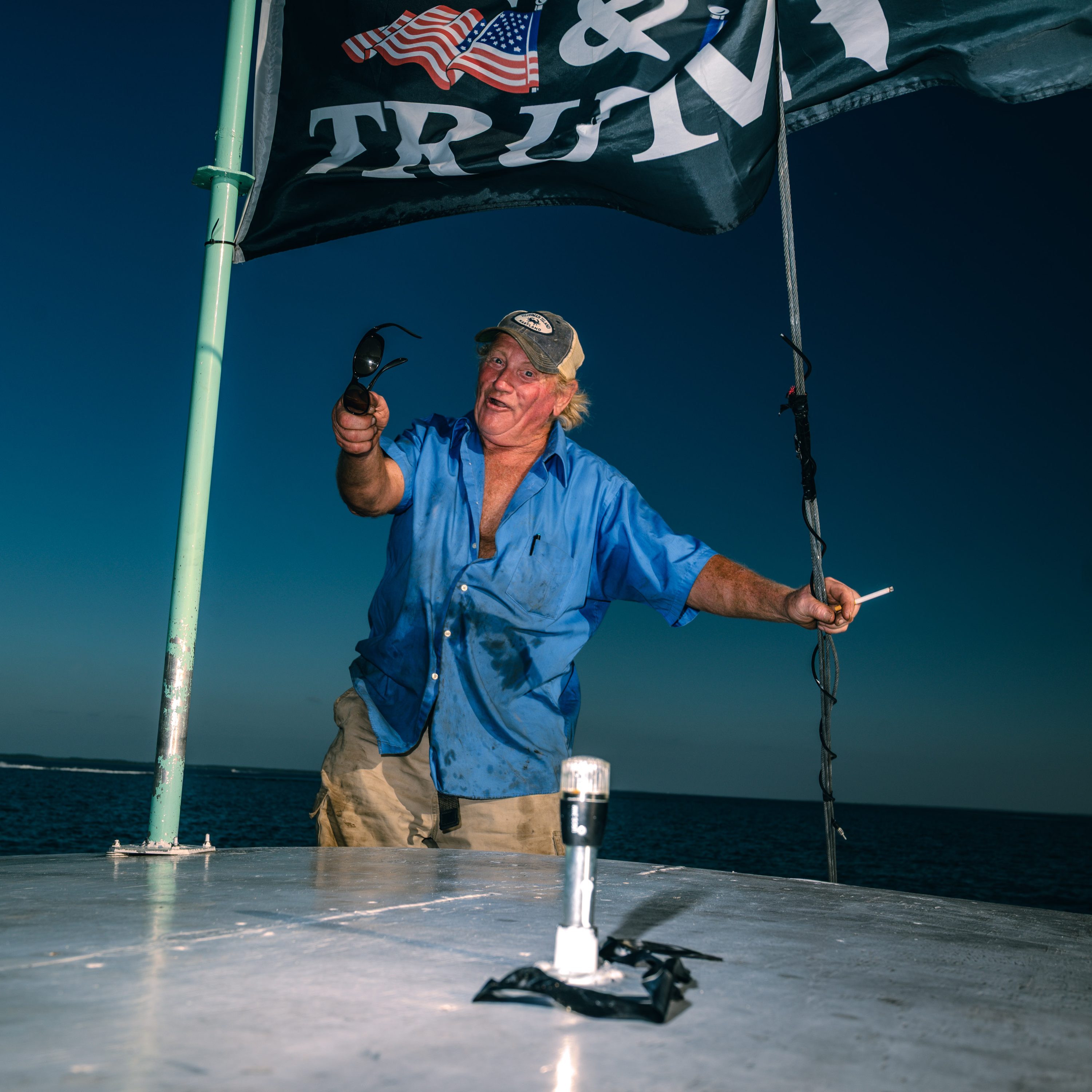 A waterman pauses at work aboard his boat.