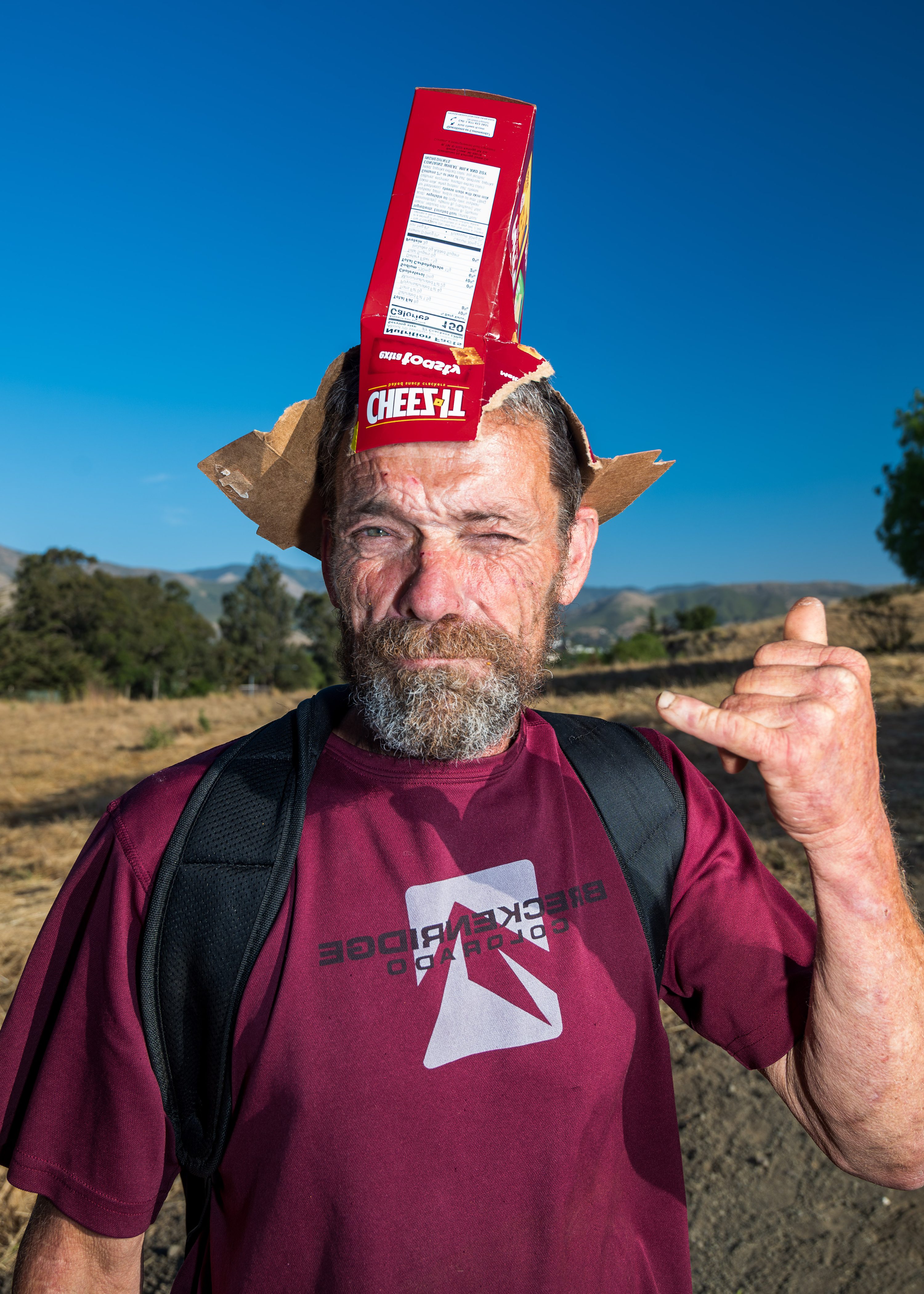 A man poses with a Cheez-It box.