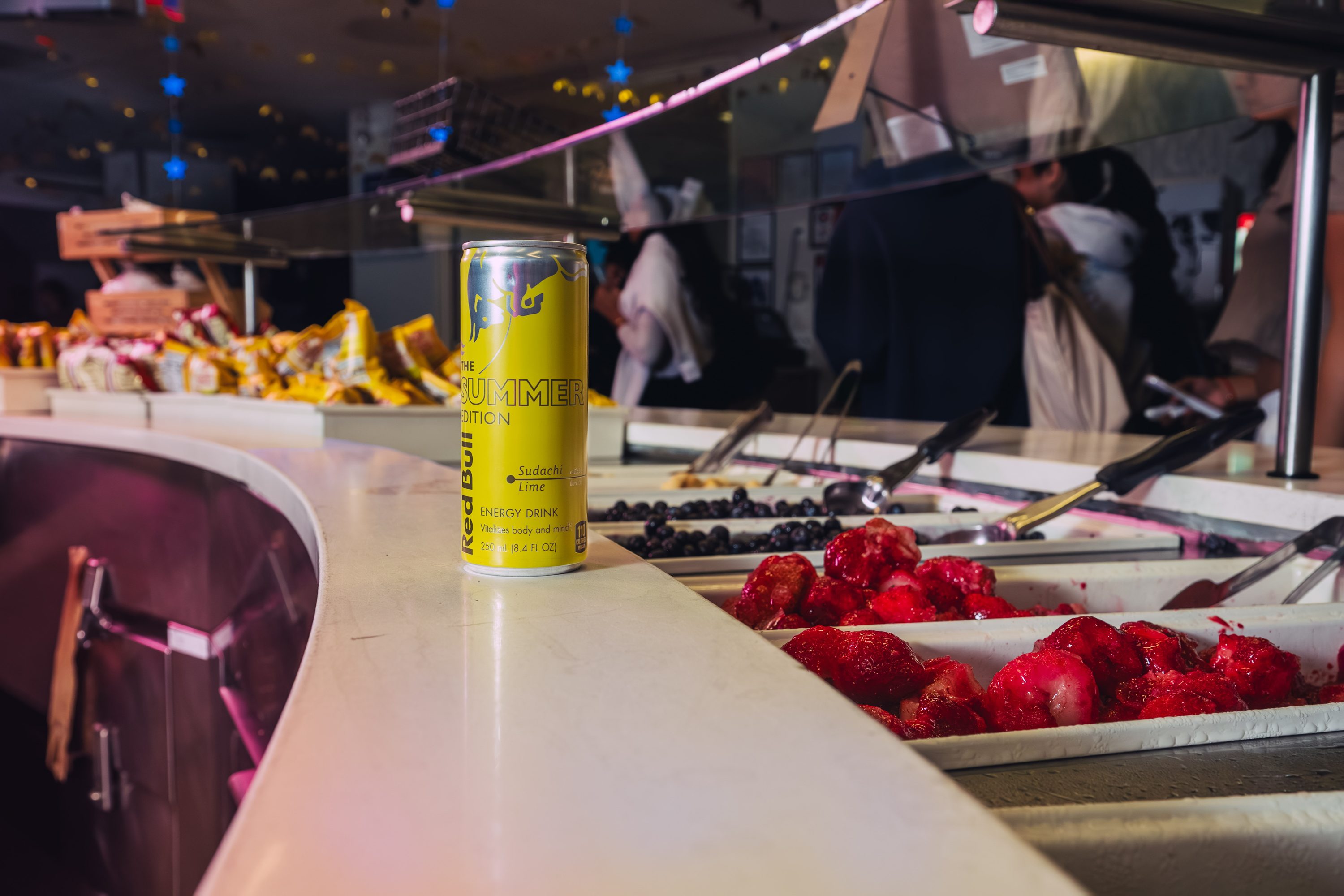 A crowd fills a Red Bull Midnight Breakfast event under red light.