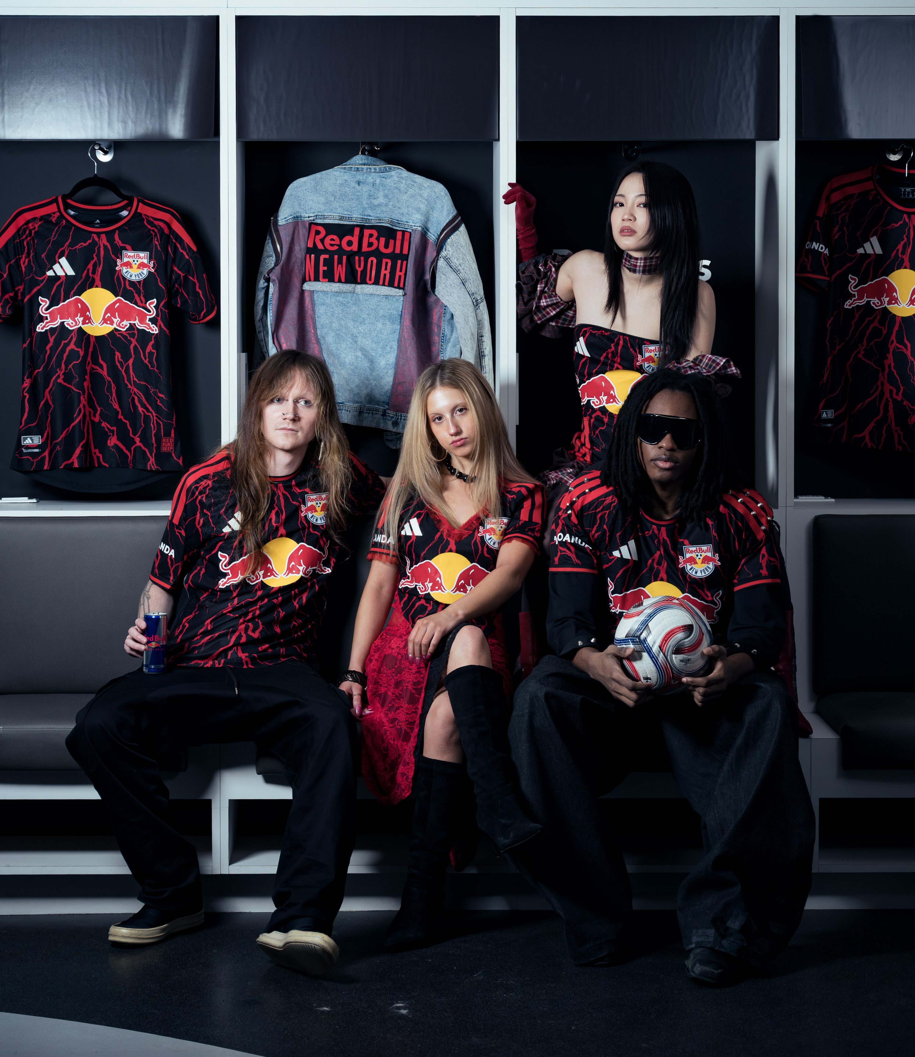 Models in Red Bull kits pose inside a locker room.