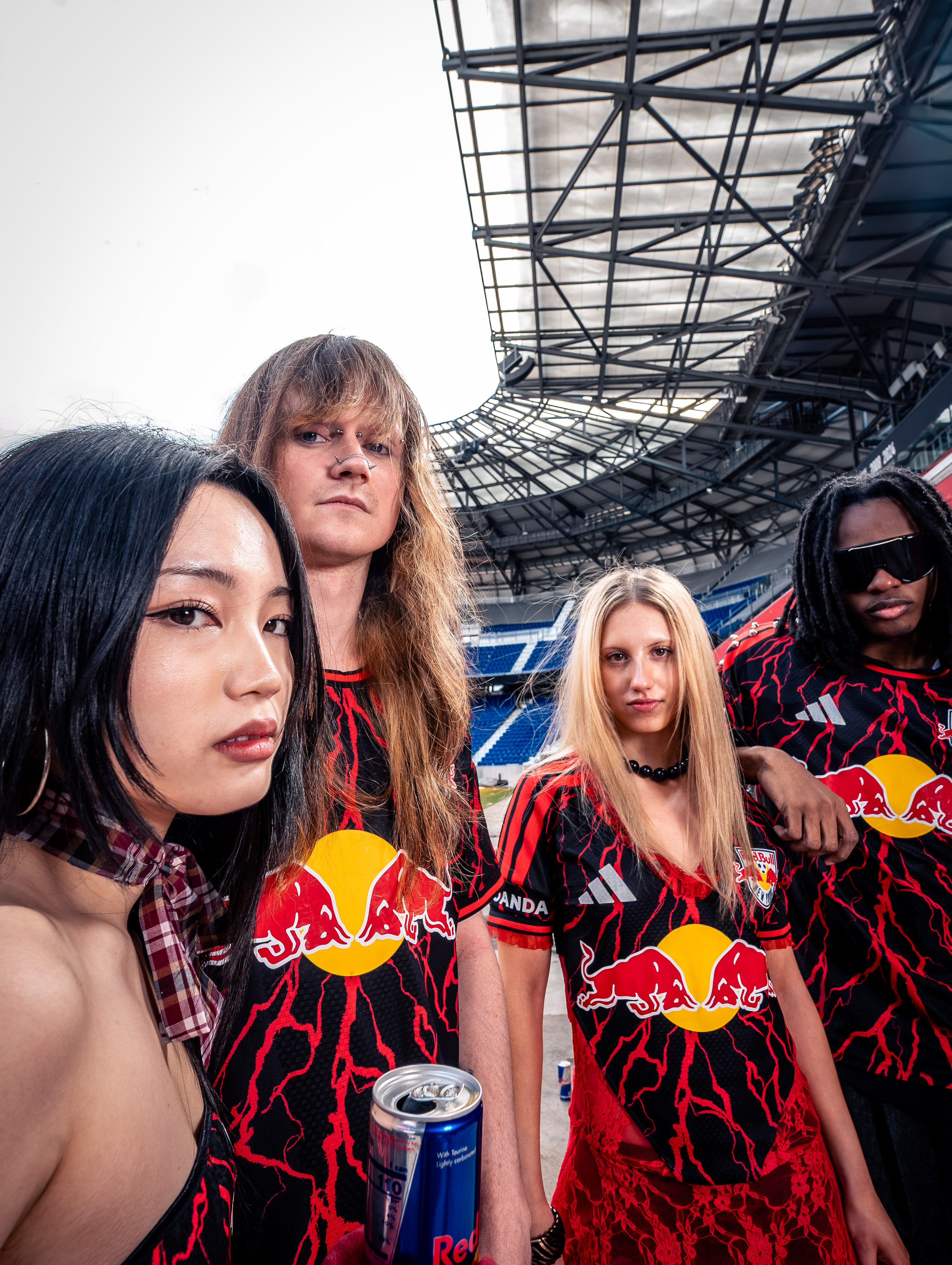 A model in a Red Bull jersey photographed among stadium seats.